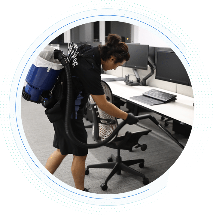 vacuuming-under-desk-with-cordless-backpack